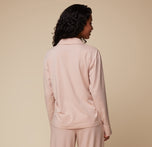 Back view of model Ally wearing the Pima PJ Longsleeve and Pima PJ Pants in Bellini. The soft fabric and relaxed fit of the loungewear set are showcased from behind.