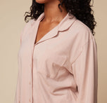 Close-up side view of model Ally wearing the Pima PJ Longsleeve in Bellini, highlighting the button detail and soft, flowy fabric of the shirt.