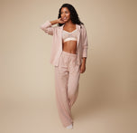 Model Ally wearing the Pima PJ Longsleeve in Bellini, left unbuttoned to reveal the Luxe Triangle Bralette in Pearl. The soft, flowy fabric emphasizes the comfortable, relaxed fit of the set.