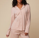 Model Ally in the Pima PJ Longsleeve and Pima PJ Pants in Bellini. The relaxed pose highlights the soft fabric and cozy fit of the loungewear set. sizing: Ally wears size Small