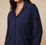 Close-up view of model Anna in the Pima PJ Longsleeve in Navy, highlighting the button details and soft fabric of the shirt.