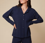 Model Anna wearing the Pima PJ Longsleeve in Navy, with her hands on her hips. The image emphasizes the soft, comfortable fabric and buttoned-up look. sizing: Anna wears size Small