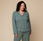 Model Bianca wearing the Pima PJ Longsleeve and Pima PJ Pants in Rainforest. The relaxed fit and soft fabric offer a cozy and comfortable loungewear look.