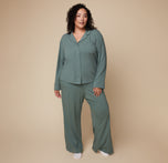 Model Bianca standing in the Pima PJ Longsleeve and Pima PJ Pants in Rainforest, showcasing the buttoned-up top and loose, comfortable fit.