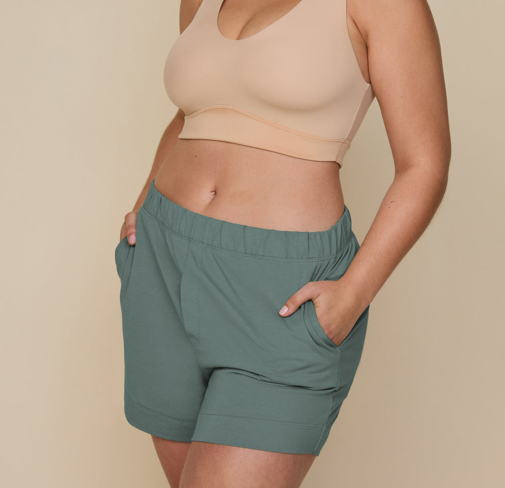 Close-up of model Summerlyn wearing Pima PJ Shorts in Rainforest (Size: L). The image focuses on the side pocket detail, highlighting the soft, comfortable fabric and relaxed fit of the shorts. sizing: Summerlyn wears size Large