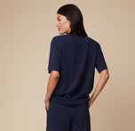 Back view of model Anna in the Pima Tee in Navy, paired with Pima PJ Pants, showcasing the relaxed, loose fit and soft fabric.