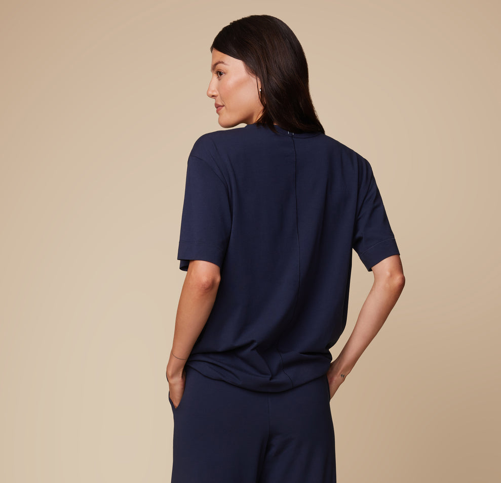 Back view of model Anna in the Pima Tee in Navy, paired with Pima PJ Pants, showcasing the relaxed, loose fit and soft fabric.