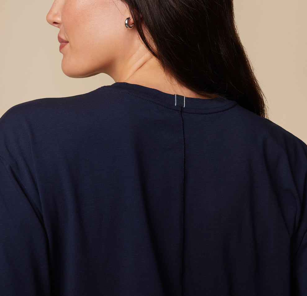 Close-up of the back of the Pima Tee in Navy worn by model Anna, focusing on the neckline and seam detail.