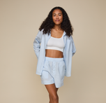Woman wears Classic Poplin Pajama Shirt in color Ice Blue