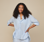 Woman wears Classic Poplin Pajama Shirt in color Ice Blue. sizing: Zoe wears size Small