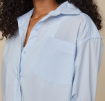 Woman wears Classic Poplin Pajama Shirt in color Ice Blue