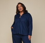 Woman wearing the Classic Poplin Pajama Shirt in color Midnight. sizing: Cassandra wears size 3XL
