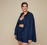Woman wearing the Classic Poplin Pajama Shirt in color Midnight. sizing: Summerlyn wears size Large