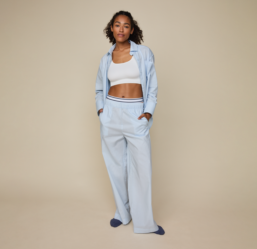 Woman wears the Classic Poplin Pajama Pant in color Ice Blue