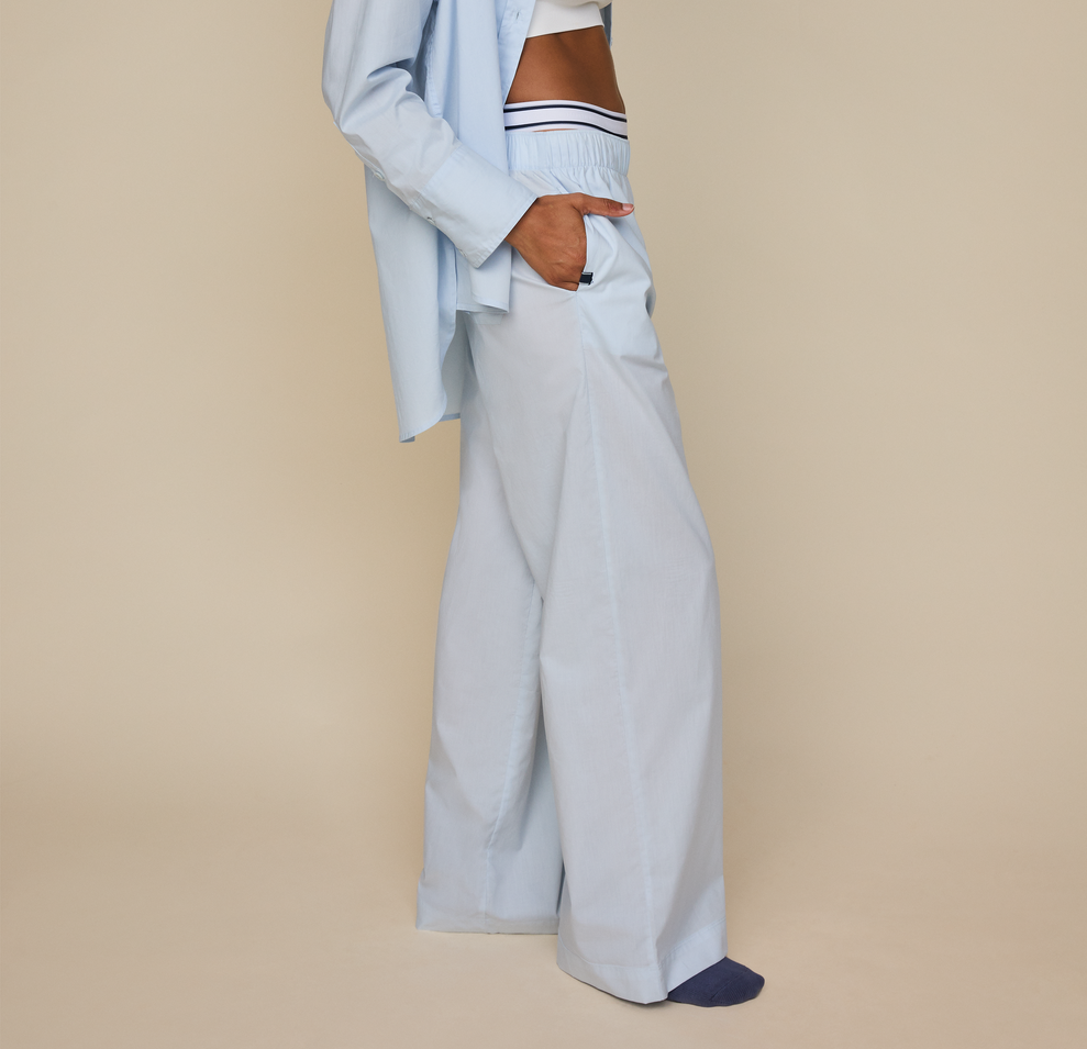 Woman wears the Classic Poplin Pajama Pant in color Ice Blue