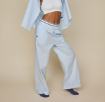 Woman wears the Classic Poplin Pajama Pant in color Ice Blue. sizing: Zoe is 5'8" wears size Small