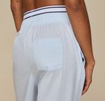 Woman wears the Classic Poplin Pajama Pant in color Ice Blue