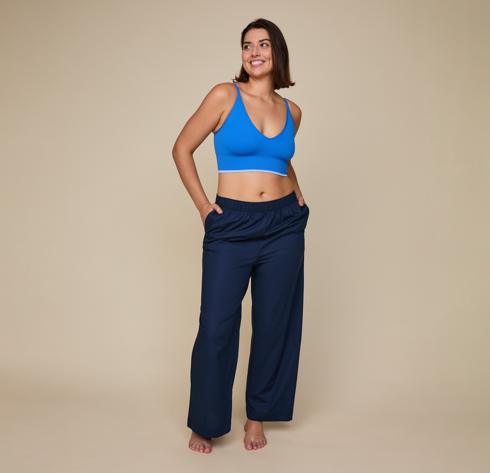 Woman wears the Classic Poplin Pajama Pants in color Midnight.