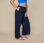 Woman wears the Classic Poplin Pajama Pants in color Midnight. sizing: Kate is 5'11" and wears size XL