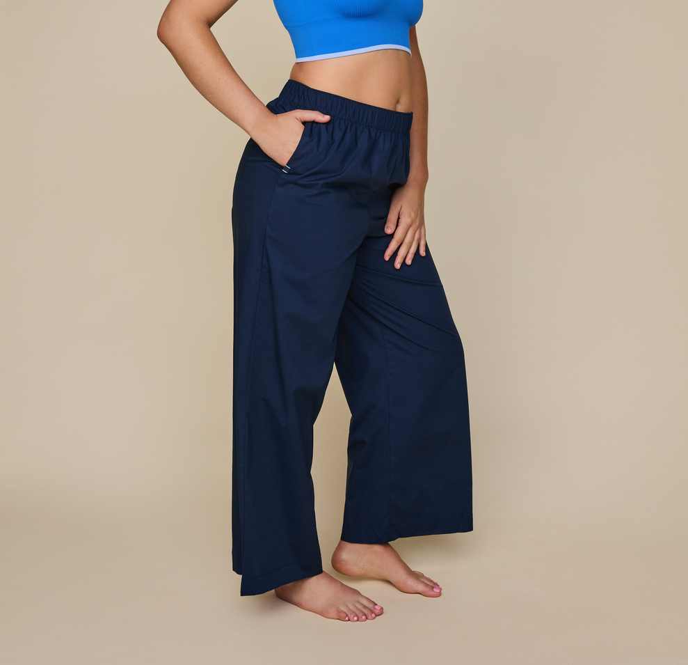 Woman wears the Classic Poplin Pajama Pants in color Midnight. sizing: Kate is 5'11" and wears size XL
