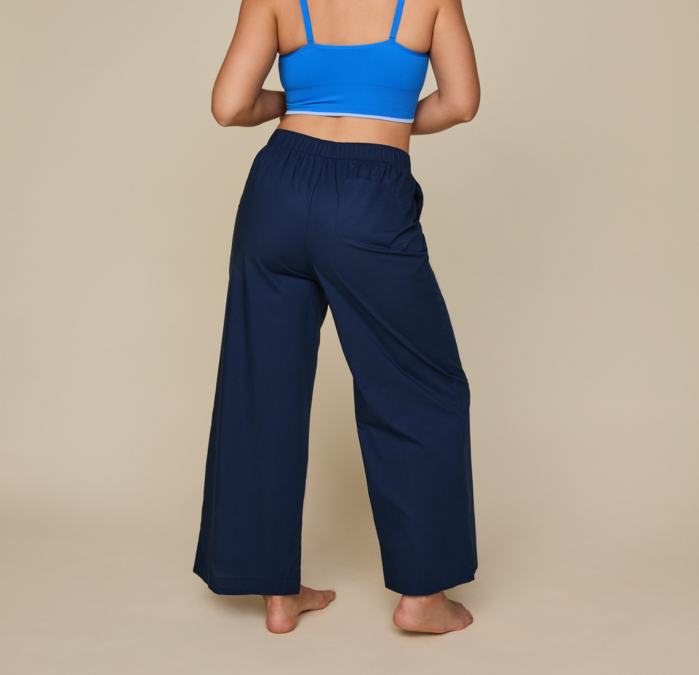 Woman wears the Classic Poplin Pajama Pants in color Midnight