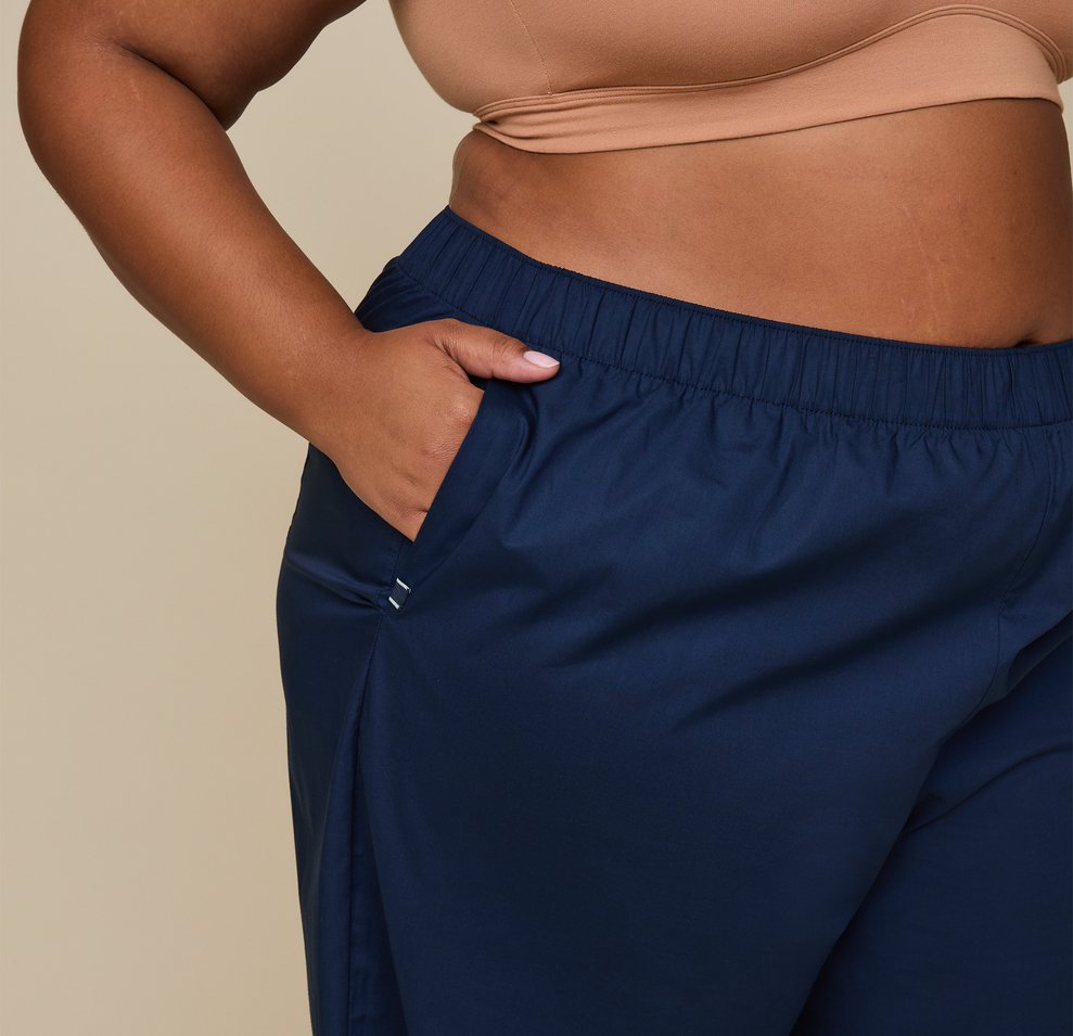 Woman wears the Classic Poplin Pajama Pants in color Midnight