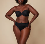 A front view of Akesha with her hands on her waist, showcasing the fit and comfortable waistline of the Bliss Hiphugger in Black.