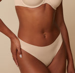 A close-up view of Ally's hip and waist area, emphasizing the soft fabric and comfortable, barely-there feel of the No Show Bikini. sizing: Ally wears size Small