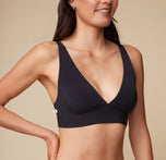 Close-up of Anna wearing the Bliss Plunge Adjustable Bralette in Black, showing the plunge neckline detail.