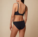 Back view of model Anna in the Bliss Plunge Adjustable Bralette and Bliss Bikini in Black, showing the adjustable straps of the bralette and the full back coverage of the bikini.