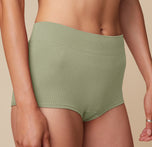 Close-up of the Lounge Boyshort in Sage on model Anna, focusing on the ribbed texture of the fabric.