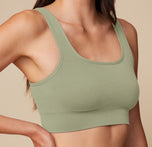 Close-up of the Lounge Scoop Bralette in Sage on model Anna, focusing on the ribbed texture and supportive scoop neckline.