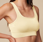 Close-up of the Lounge Scoop Bralette in Sunnyside on model Anna, showcasing the ribbed fabric and scoop neckline for a casual, cozy style.