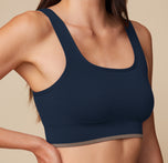 Close-up of the Lounge Scoop Bralette in True Blue on model Anna, focusing on the ribbed texture, wide straps, and scoop neckline for a comfortable fit.