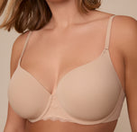 Close-up of Sonnie wearing the Base Lace T-Shirt Bra in Beige. The image highlights the contour of the lightly lined cups, the silky microfiber fabric, and the delicate lace detail at the center front and band.
