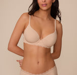 Marcela wearing the Base Lace T-Shirt Bra in Beige. A front-facing view showcasing the lightly lined underwire cups, front-adjustable straps, and lace trim along the band for a comfortable, lifted fit. sizing: Marcela wears size 32D 