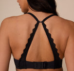 Marcela wearing the Base Lace T-Shirt Bra in Black with the straps clipped into a racerback using the built-in J-hook. The lace trim creates a supportive and stylish back detail.