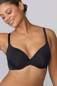 Close up of India wearing the Base Push-Up Bra in Black. The lightly lined underwire cups create lift and shape, finished with thin adjustable straps and a smooth microfiber band. sizing: India wears size 36D