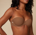Close-up shot of Ally’s upper body in the Base Strapless Bra in Brown, focusing on the smooth cups and supportive band.