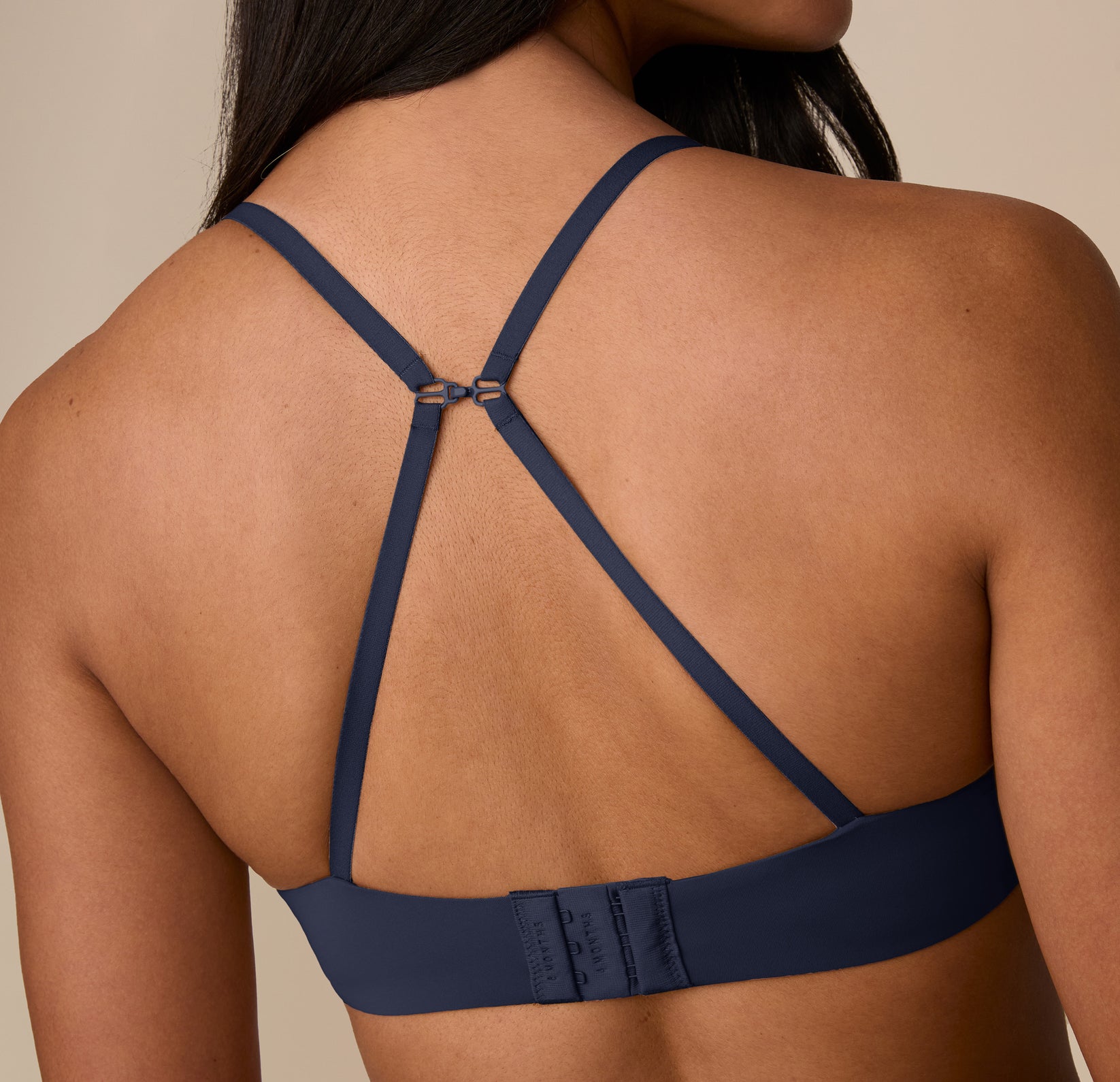Back view of the Base T-Shirt Bra in racerback mode on Nemesis, showcasing the J-hook that easily converts the straps for additional support and versatility.