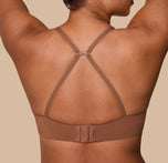 India demonstrates the racerback conversion of the Base T-Shirt Bra in Brown, showing the versatility of the adjustable straps.