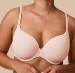 A close-up image of India wearing the Base T-Shirt Bra in Rose, focusing on the ultra soft fabric and lightly contoured cups.