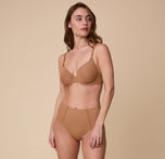 Full-body image of Gracie wearing the Base T-Shirt Bra in Tan with the matching No-Show Highwaist Brief, emphasizing the bra’s comfortable and supportive fit.