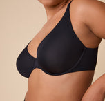 A close-up side view of the Base Unlined Bra in Black on India, showcasing the soft fabric, unpadded cups, and underwire structure.