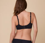 A back view of Gracie in the Base Unlined Bra in Black, showcasing the adjustable straps, convertible racerback feature, and hook closure.