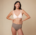 Anna faces the camera wearing the Base Unlined Bra in Quartz. The front adjustable straps and plunge neckline are emphasized. sizing: Anna wears size 32C