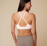 A back angle shot of Anna wearing the Base Unlined Bra in Quartz in Racerback fashion. 