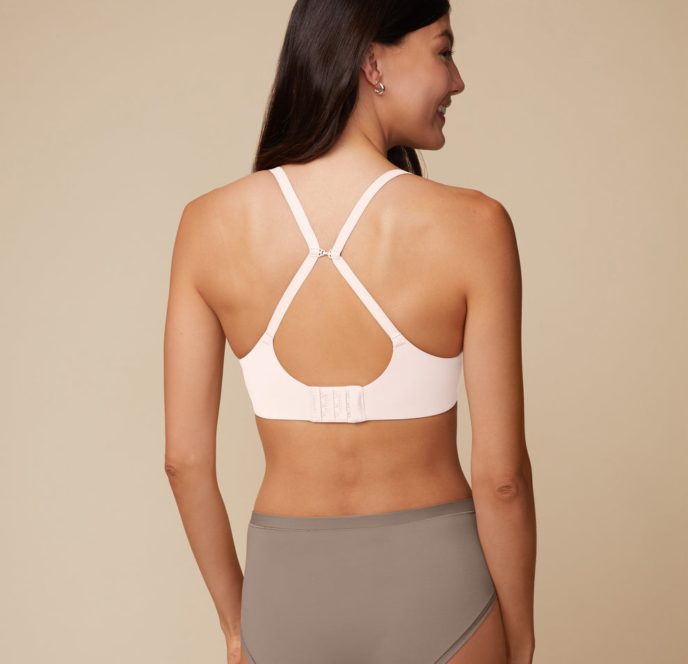 A back angle shot of Anna wearing the Base Unlined Bra in Quartz in Racerback fashion. 