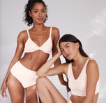 Anna and Ally pose together wearing matching Quartz sets. Ally wears the Base Unlined Bra. Different body types and skin tones are emphasized. 