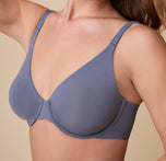 A close-up of Gracie wearing the Base Unlined Bra in Steel, emphasizing the soft, unlined cups and supportive underwire for a barely-there feel.
